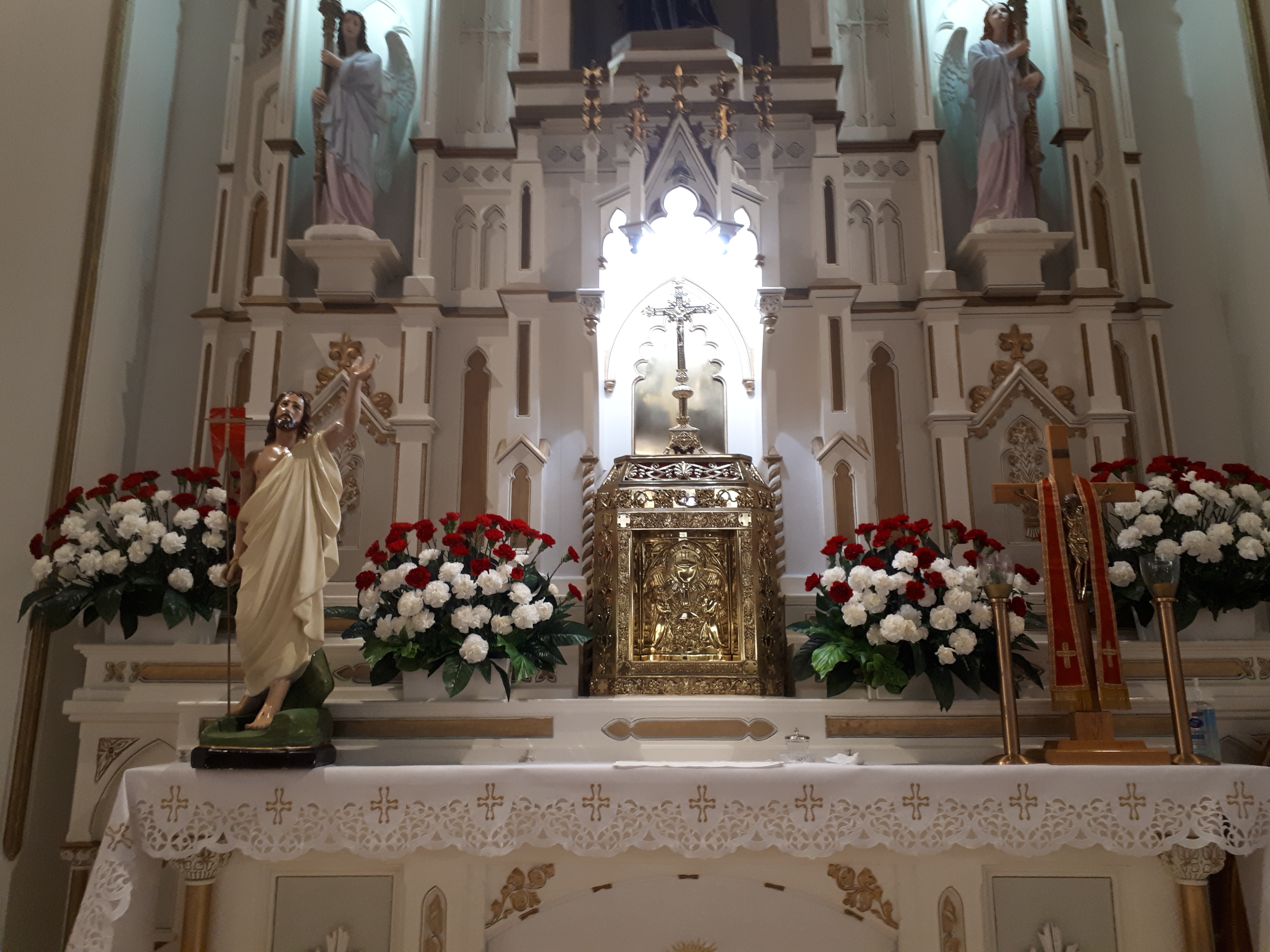 Main Altar decorated with red & white carnations